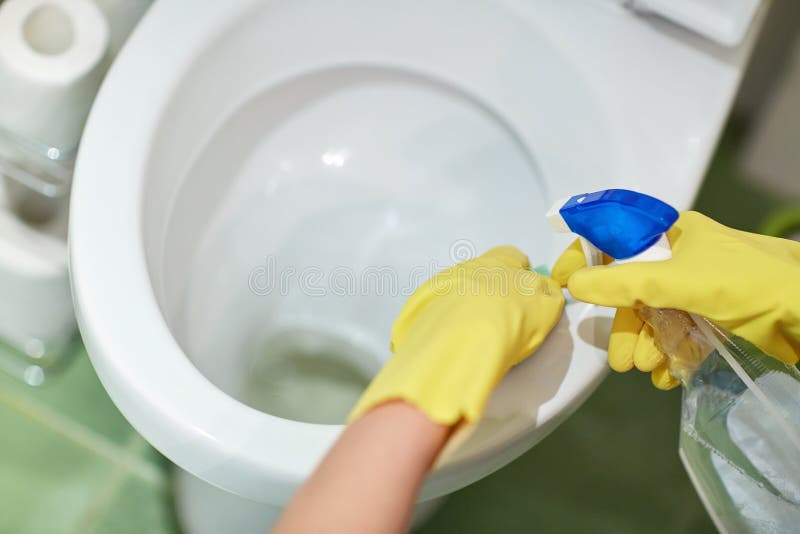 Schließen Sie oben von der Hand mit reinigender Reinigungstoilette stockbild Schließen Sie oben von der Hand mit reinigender Reinigungstoilette stockbild