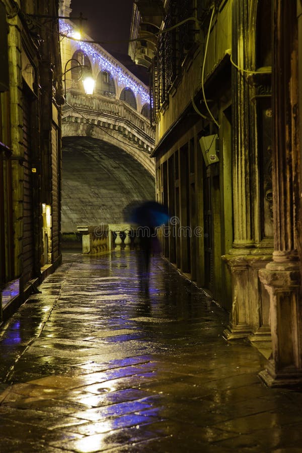 Narrow alley in Venice, with view on the Rialto Bridge, at night. Narrow alley in Venice, with view on the Rialto Bridge, at night