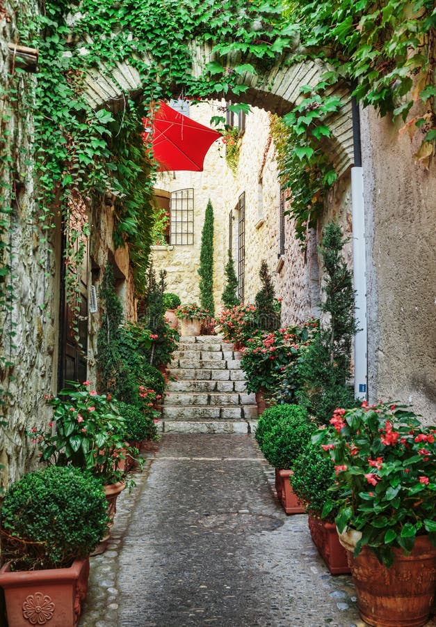 Narrow street with flowers in the old town in France. Narrow street with flowers in the old town in France.