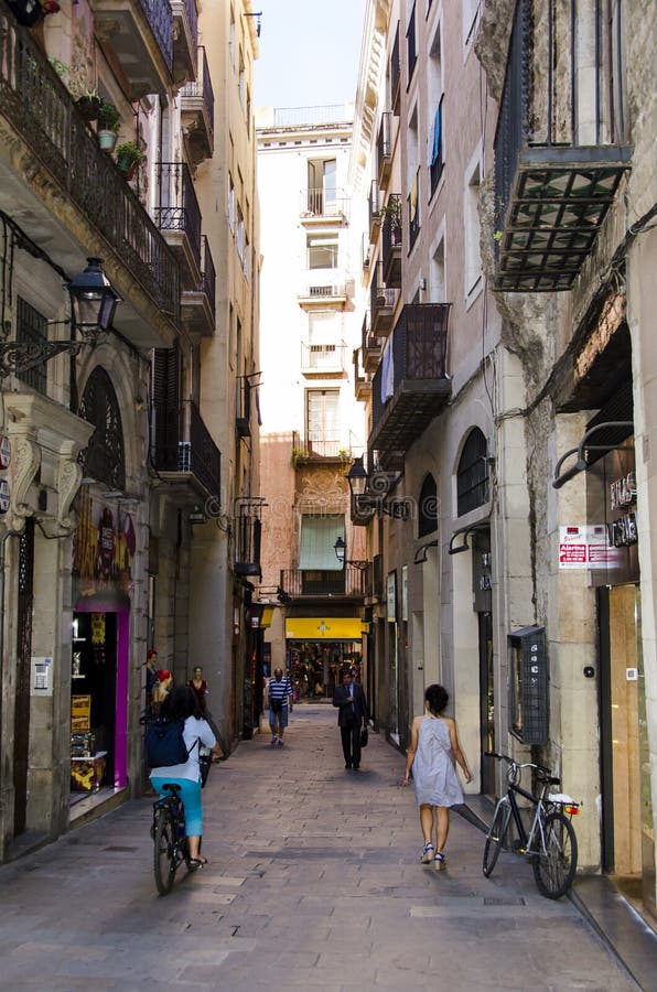 A view along a narrow alley or passageway through the historic section of Barcelona, Spain. A view along a narrow alley or passageway through the historic section of Barcelona, Spain.