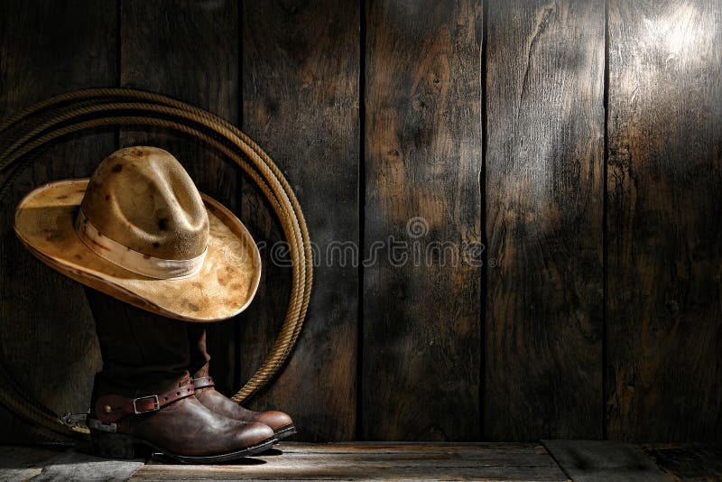 Amerikanischer Westrodeo-Cowboyhut auf Stiefeln und Lariat