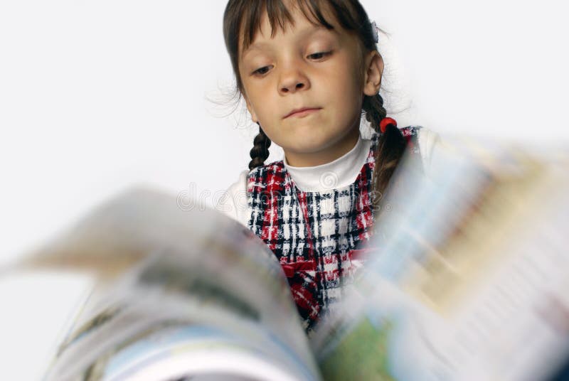 The girl quickly thumbs through the book. The girl quickly thumbs through the book