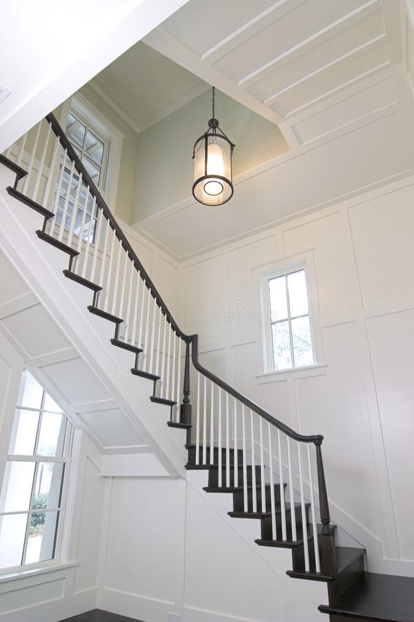Curved staircase in expensive home with white woodwork. Curved staircase in expensive home with white woodwork