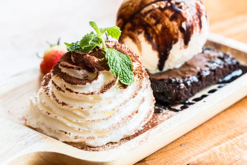 Schokoladenkuchen und Eiscreme in den hölzernen Schüsseln zu kreativem für Design lizenzfreies stockfoto Schokoladenkuchen und Eiscreme in den hölzernen Schüsseln zu kreativem für Design lizenzfreies stockfoto