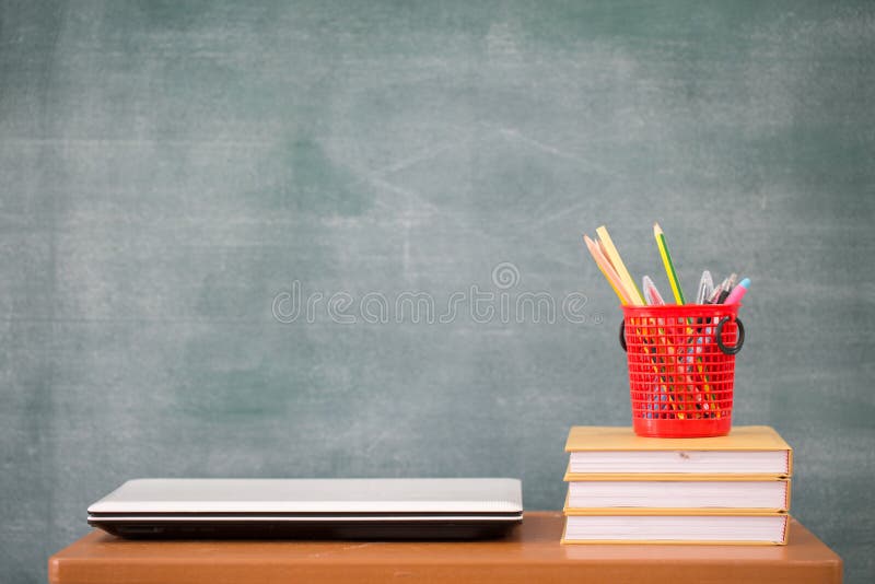 School books on desk, school supplies. Books and blackboard background, Online education, education concept