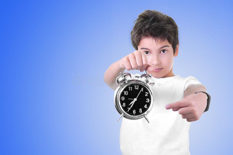 School Boy with Alarm Clock in Hands Isolated on Blue. Time To Go Stock