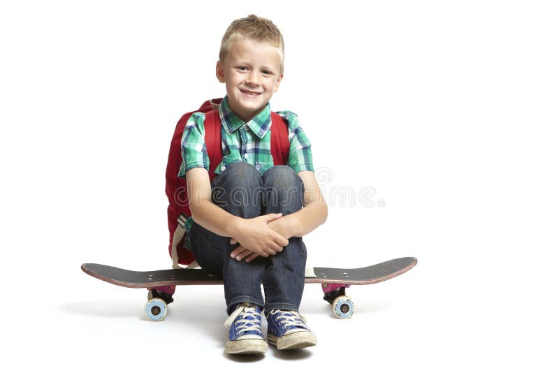 School boy sitting on a skateboard stock image School boy sitting on a skateboard stock image