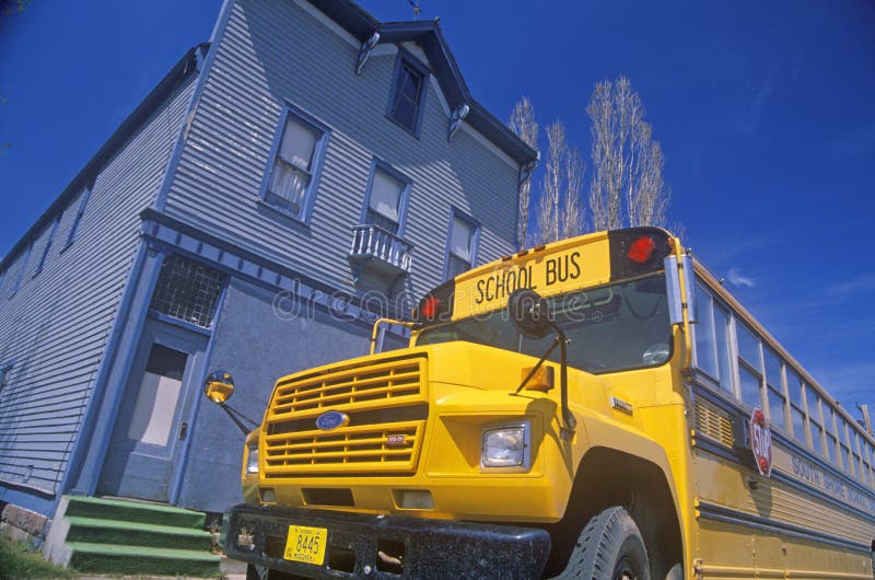A school bus parked in front of an old building, Port Wing, Wisconsin royalty free stock image A school bus parked in front of an old building, Port Wing, Wisconsin royalty free stock image