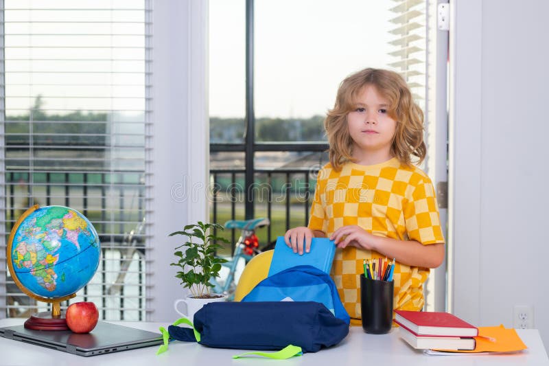 School Child Puts School Supplies in a Backpack. Preparation for School