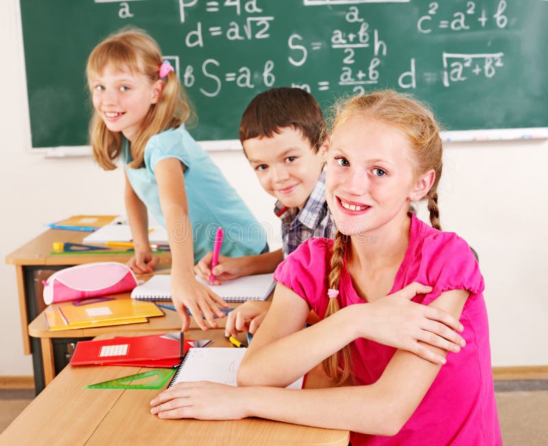 School child sitting in classroom. stock photo