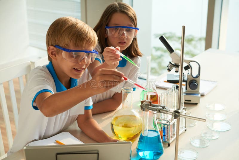 Kids Watching Lab Technician Carry Out A Science Experiment Stock Photo ...