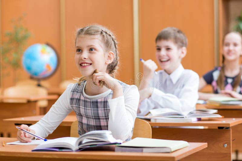 School children at lesson in classroom royalty free stock photo