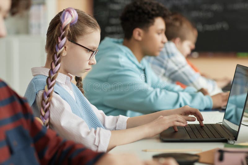 School children using computers in row royalty free stock images