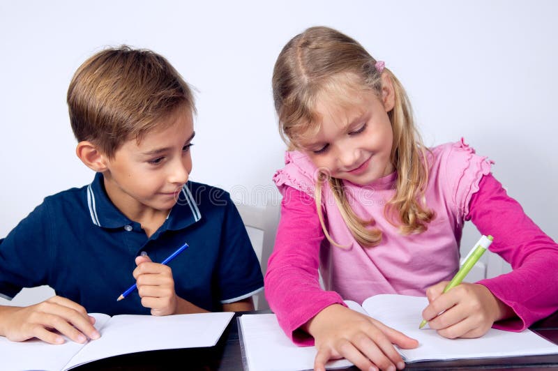 School children writing together