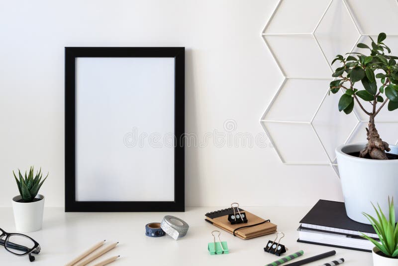 School desk against an empty white wall. Black frame mockup