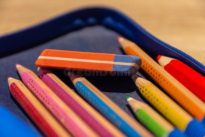 A School Folder with Colored Pencils and an Eraser Stock Photo Image