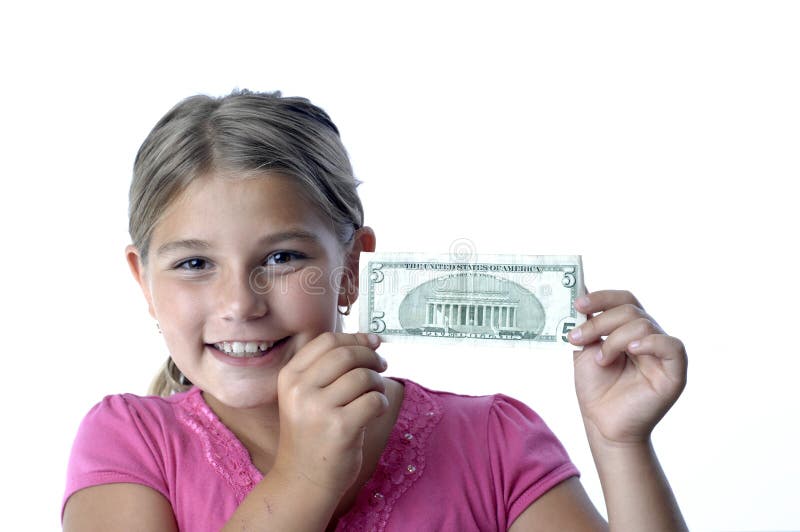 School girl is playing with a paper bills before putting them into the piggy bank. School girl is playing with a paper bills before putting them into the piggy bank.