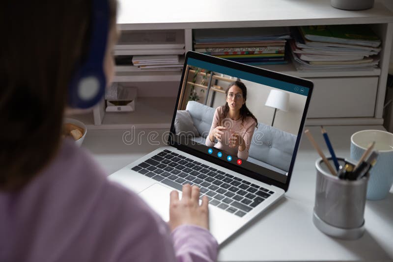 School girl student studying with online teacher on computer screen stock photos