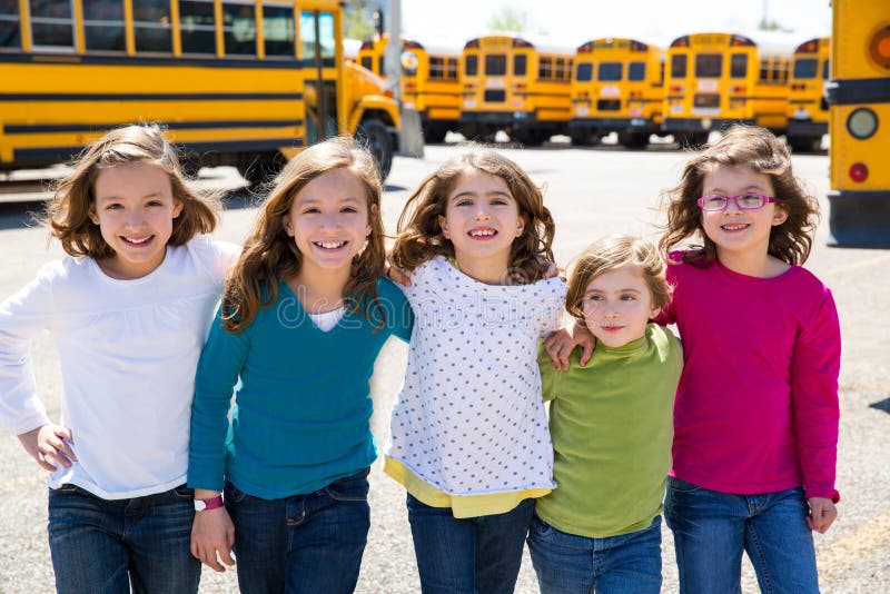 School girls friends in a row walking from school bus royalty free stock images School girls friends in a row walking from school bus royalty free stock images