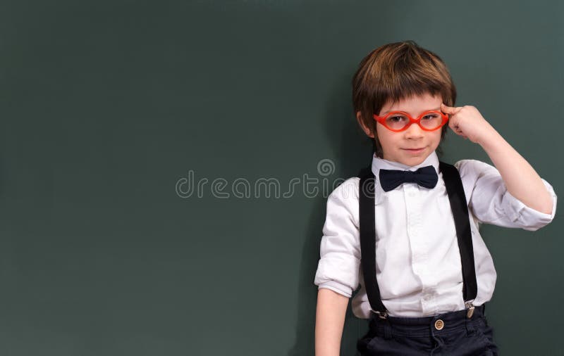 School intelligent child develops idea in the empty blackboard