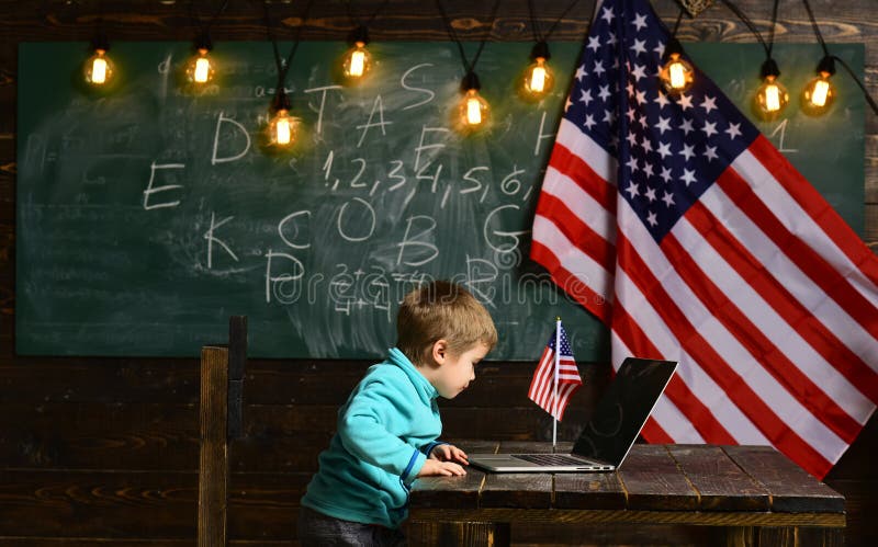 School kid at lesson in 4th of july. Happy independence day of the usa. Little boy with laptop for business at American