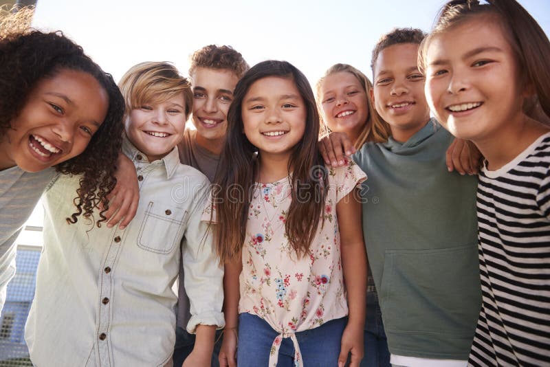 School kids hanging out during break, smiling to camera. Happy multiethnic boys stock images, royalty-free photos and pictures