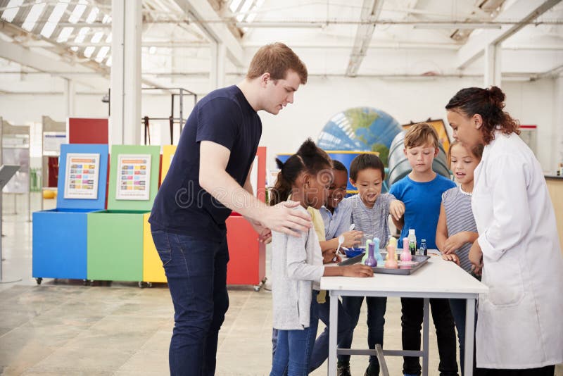 School Kids Taking Part in Experiment at Science Centre Stock Photo