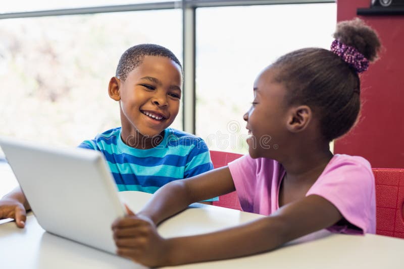 School kids using a digital tablet in classroom stock photos