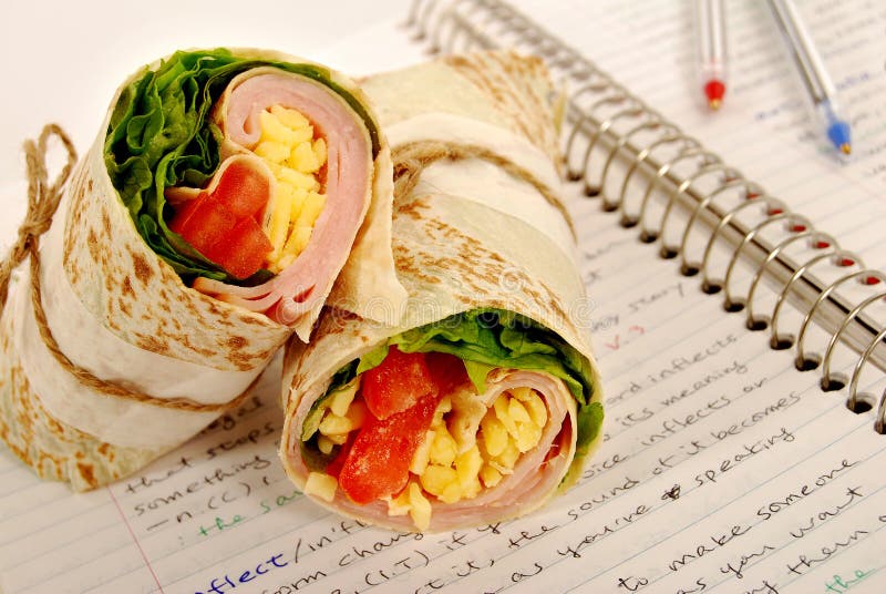 School Lunch Ham and Cheese Wrap Sandwich on Notebook Stock Photo