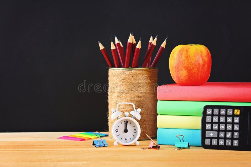 School and office supplies on a black chalkboard background. Back to school.