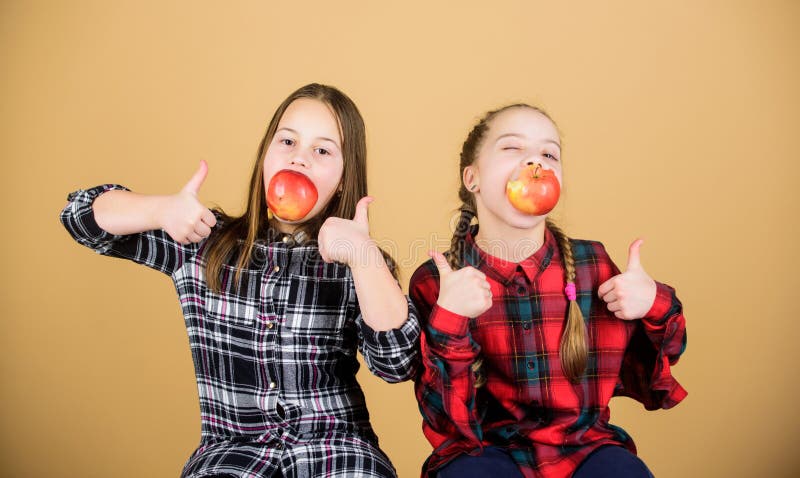 School snack concept. Teens with healthy snack. Cheerful kids having fun and eating apples. We are on healthy diet stock photo School snack concept. Teens with healthy snack. Cheerful kids having fun and eating apples. We are on healthy diet stock photo