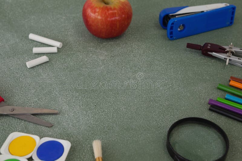 School Supplies and Apple Arranged on Chalkboard Stock Image Image of