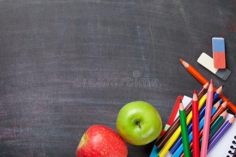 School supplies on blackboard background royalty free stock image