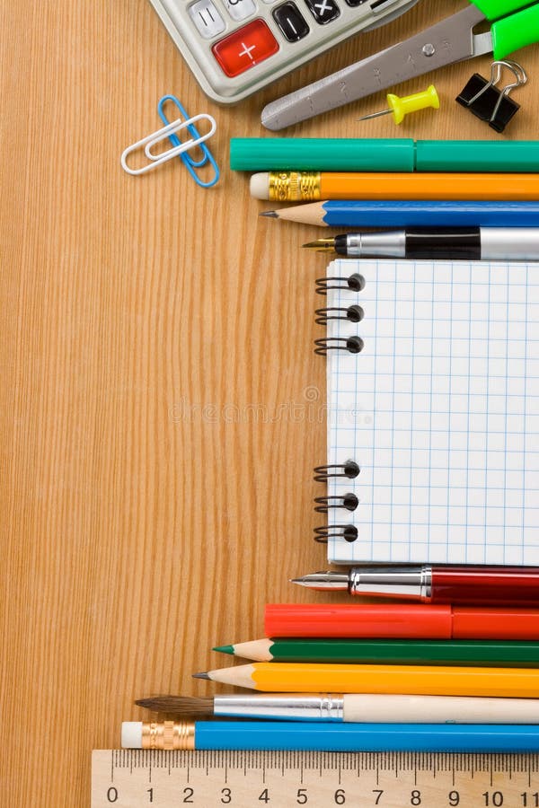 School supplies and checked notebook on wood royalty free stock photography School supplies and checked notebook on wood royalty free stock photography