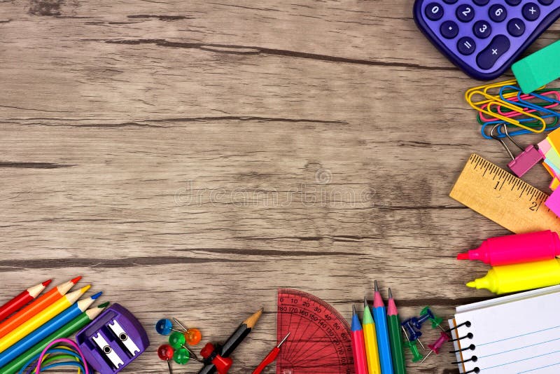 School supplies corner border against a rustic wooden background. School supplies corner border against a rustic wooden background