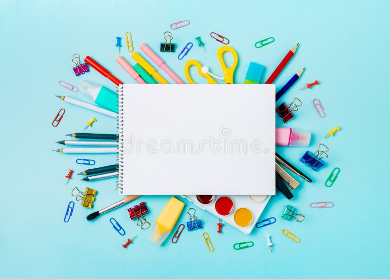 School supplies and empty notebook on blue bckg royalty free stock photos