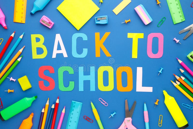 School Supplies with Inscription Back To School on Blue Background