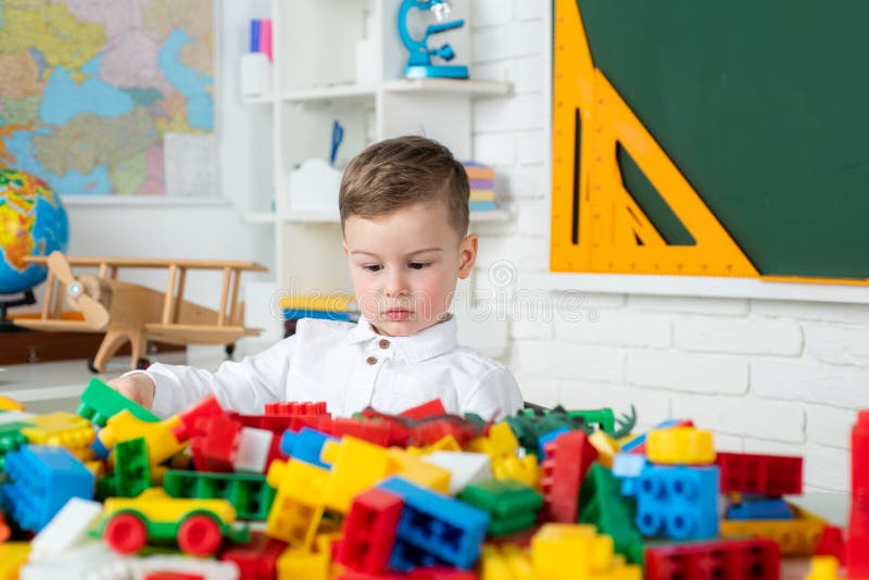 Schoolboy boy studies at home and does school homework. Elementary school boy. Concept of education and reading. royalty free stock photography