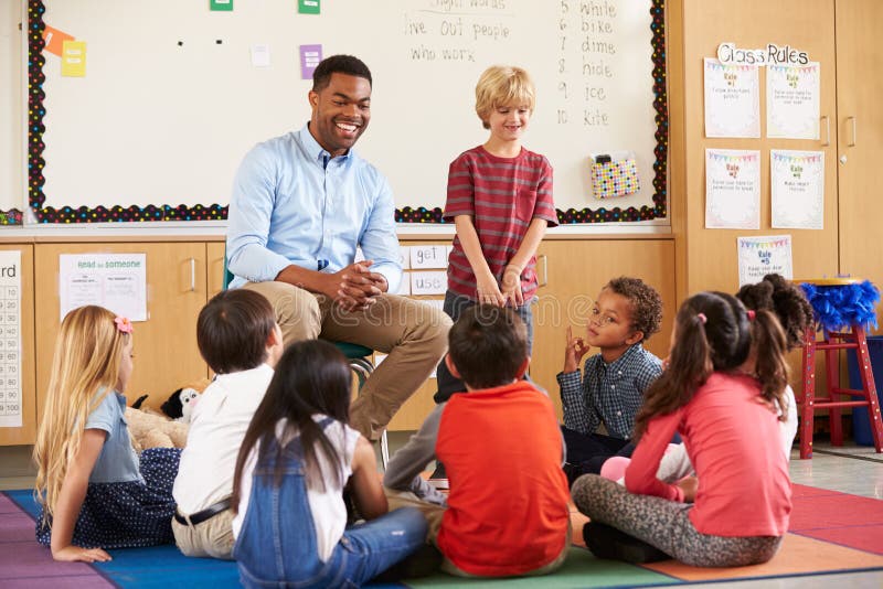 Schoolboy at the front of elementary class with teacher