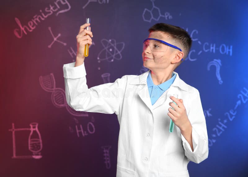 Schoolboy with test tubes against blackboard with chemistry formulas stock images Schoolboy with test tubes against blackboard with chemistry formulas stock images