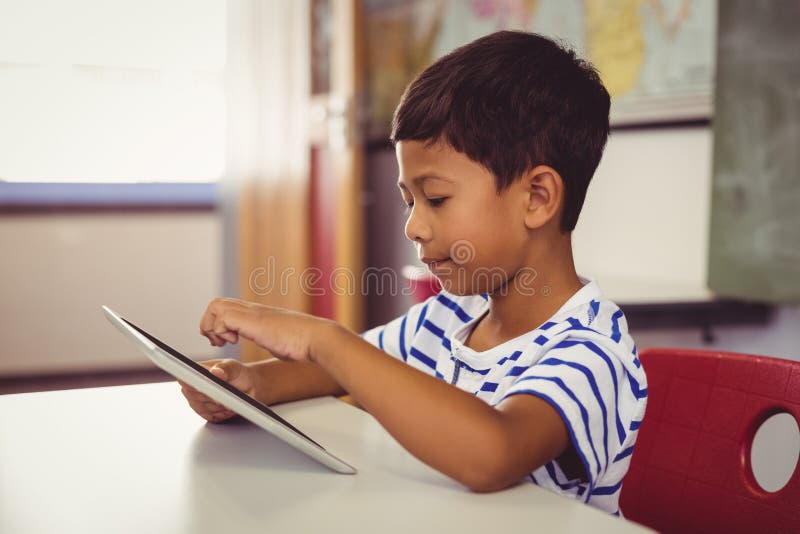 Schoolboy Using Digital Tablet in Classroom Stock Image Image of