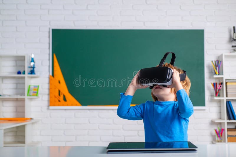 Schoolboy with vr goggles in school classroom. Individual teaching. royalty free stock photography