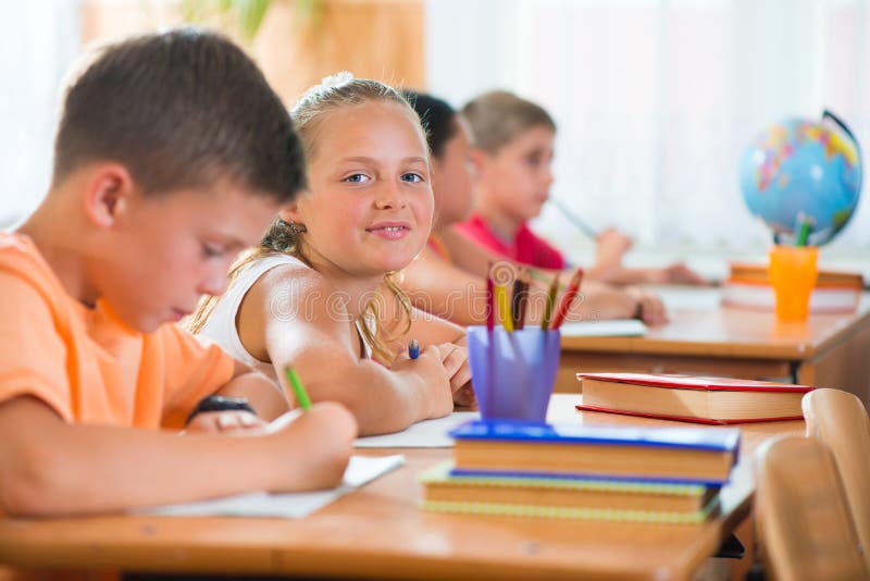 Schoolchildren in classroom at school royalty free stock photography