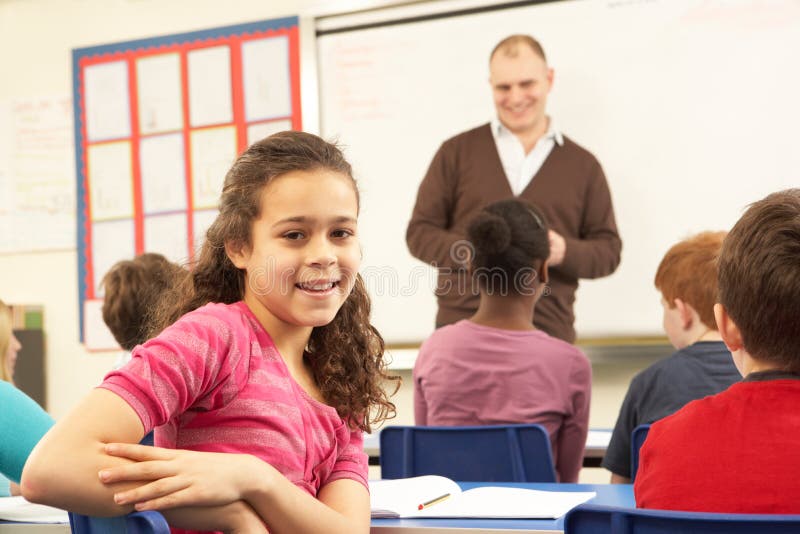 Schoolchildren Studying In Classroom With Teacher smiling. Smiling asking stock images, royalty-free photos and pictures
