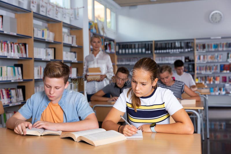 Schoolers reading in college library