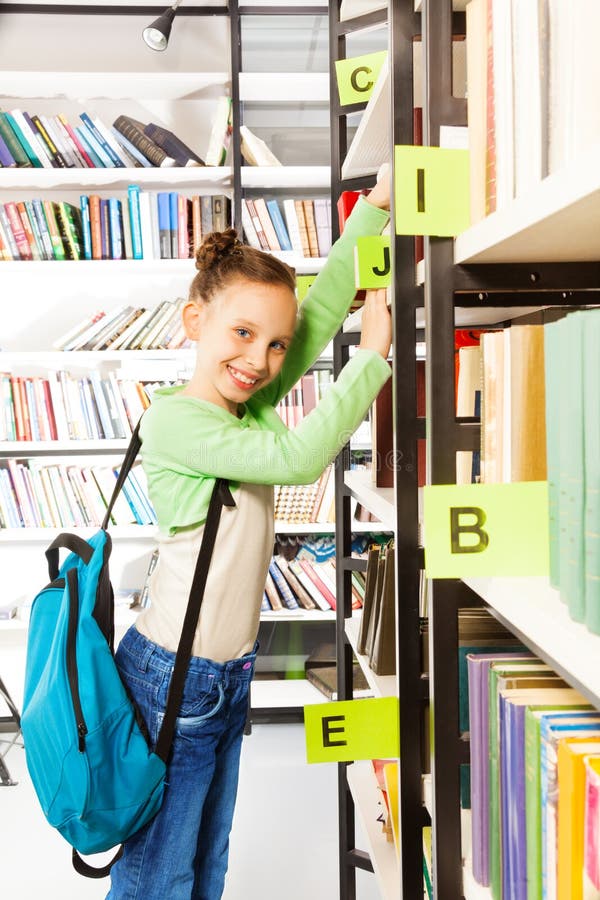 Schoolgirl with blue bag searching books