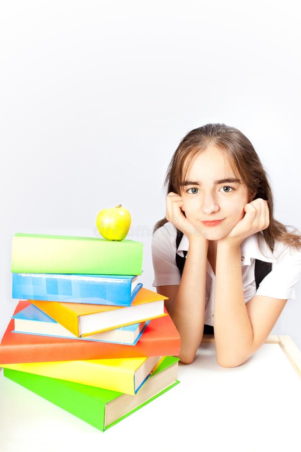 Schoolgirl and books and apple stock photos