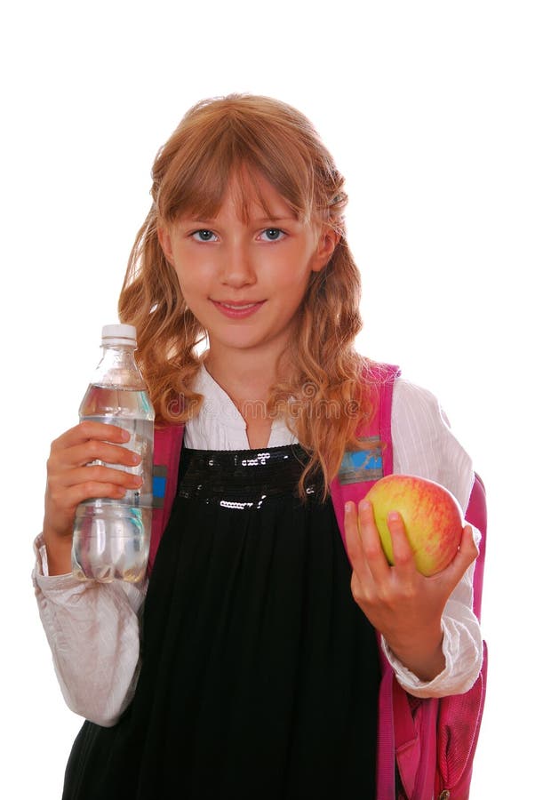 Schoolgirl with bottle of water and an apple stock photos