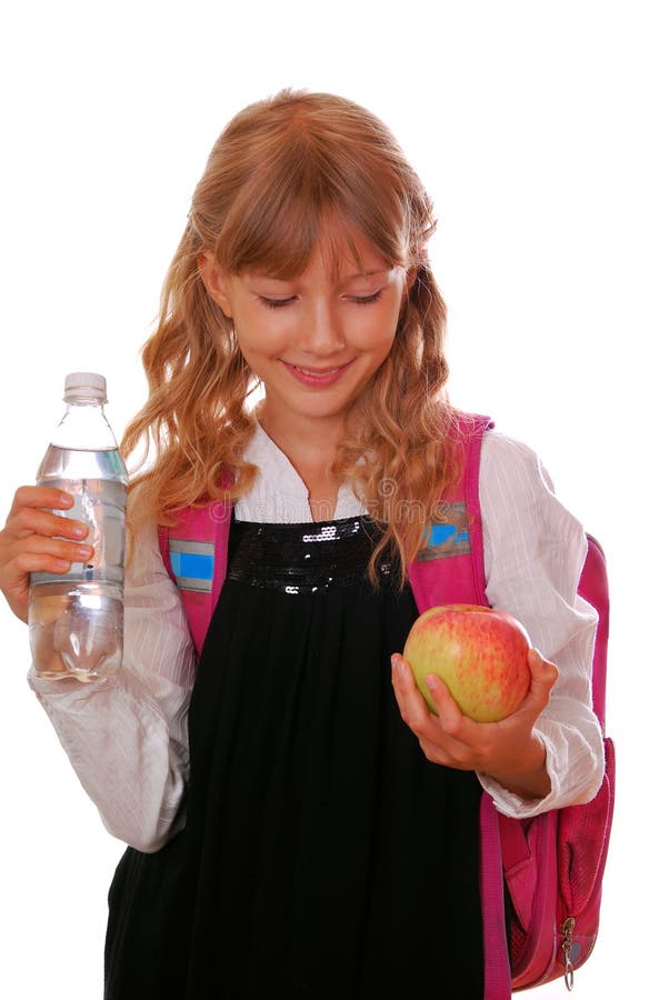 Schoolgirl with bottle of water and an apple stock photos