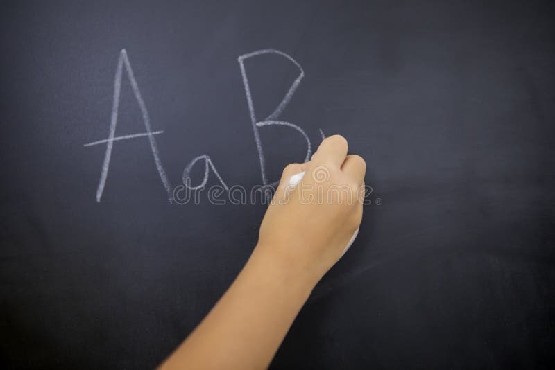 Schoolgirl hand writes alphabet letters stock photography Schoolgirl hand writes alphabet letters stock photography
